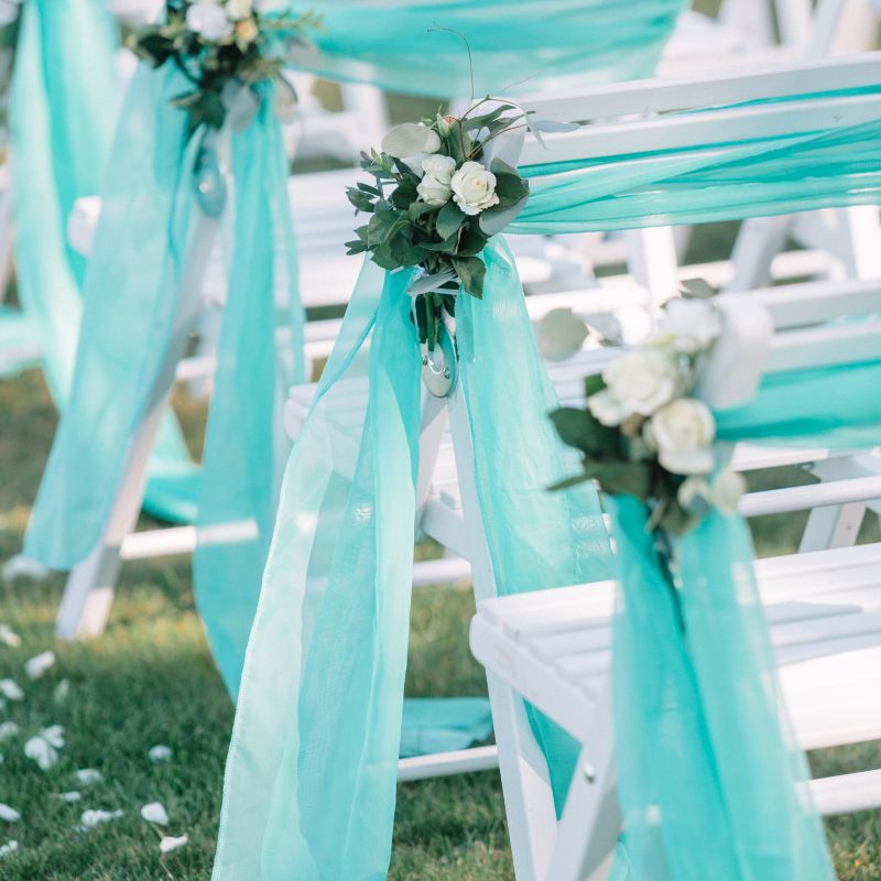 white-chairs-guests-decorated-with-mint-cloth
